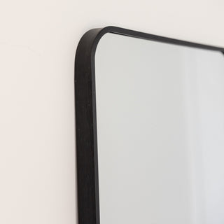A close-up shot of the Lithe X Full-Length Mirror’s sleek black frame, showcasing its smooth rounded edges and premium aluminium alloy construction. A perfect blend of durability and minimalist design for any modern space. | C&F Creation