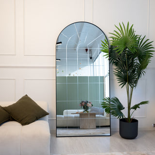 Elegant Renley 190x90cm arched engraving full-length mirror leaning against a wall in a modern interior – a statement piece by C&F Creation