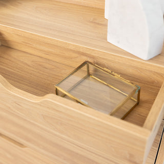 Close-up of the Risa Slim Shoe Cabinet’s top drawer in oak finish, showing a glass jewellery box inside. The smooth oak texture and cut-out handle design highlight the cabinet’s practical and minimalist style.