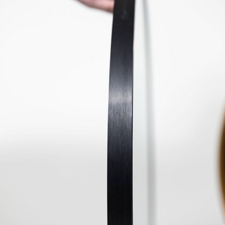 Detailed side profile of the brushed black aluminium alloy frame on the Valor Round Wall Mirror, showcasing its sleek and modern finish | C&F Creation