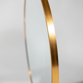 Detailed side profile of the brushed gold aluminium alloy frame on the Valor Round Wall Mirror, highlighting its sleek design and premium finish | C&F Creation