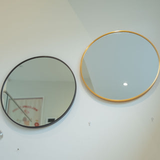 Valor Round Wall Mirrors with sleek black and gold aluminium alloy frames, displayed side by side on a white wall in a minimalist setting | C&F Creation