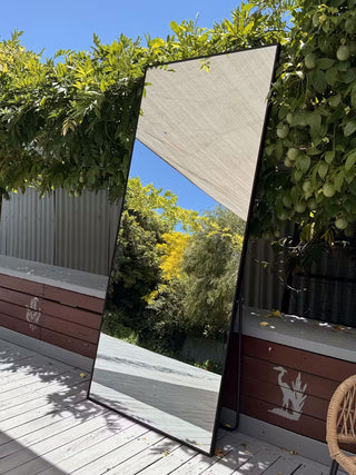 A Zenith Straight Edged Full-Length Mirror (180x80 cm) showcased outdoors with a 5-star customer review praising its sleek design, distortion-free reflection, and perfect full-length size.