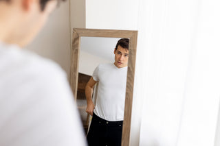 Person viewing their reflection in a mirror from different angles and distances