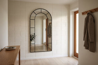 Bastia X black arched window mirror, 200 x 100cm, hung on a painted concrete block wall in the entry hall of a New Zealand home, bottom edge clear of the skirting