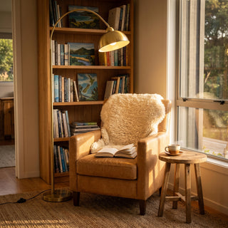 Floor reading lamp test: the Orsay gold arc floor lamp and a reading armchair with an open book