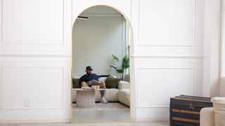 Grandeur Aurelia arched full length mirror 200 x 100cm styled in a modern New Zealand living room, reflecting a calm neutral sofa setting and adding height, light, and softness to the space