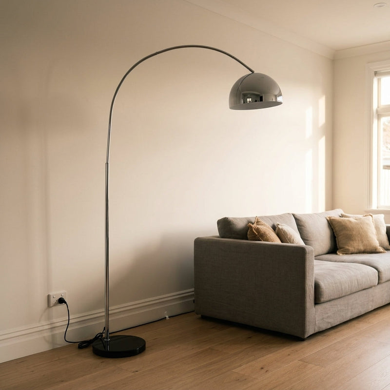 Floor lamp cable management NZ — chrome and white marble base floor lamp with cord routed neatly along the skirting board to a wall power point in a Kiwi living room