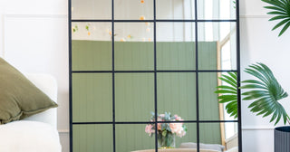 Le Vue black window pane wall mirror reflecting window light into a New Zealand living room