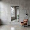 C&F Creation Aldren X Rectangular Full Length Mirror 200x100cm black frame against industrial concrete wall
