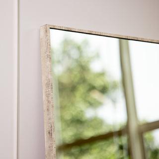 Close-up of the Branewood Straight Edged Full-Length Mirror featuring a newly designed PS frame with a natural wood-textured finish. The 4mm clear glass reflects a bright interior scene, showcasing its versatile wall-hanging design suitable for both vertical and horizontal installation — perfect for modern New Zealand homes and interior décor styling.