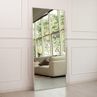 Branewood full-length mirror with a light wood-textured PS frame placed against a modern white panelled wall. The 180x80cm mirror features 4mm clear glass that reflects a cosy lounge with soft natural light, offering a timeless look ideal for both wall-mounted and floor display in contemporary New Zealand homes.