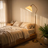 Aurelia Pleated Fabric Floor Lamp casting a soft warm glow beside the bed in a cosy bedroom