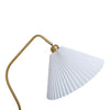 Close up of the Aurelia Pleated Fabric Floor Lamp white pleated fabric shade and curved brass arm on white background
