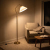 Aurelia Pleated Fabric Floor Lamp switched on in the evening, filling the room with warm night light
