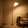 Aurelia Pleated Fabric Floor Lamp switched on in the evening, filling the room with warm night light