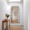 Bastia Aurelia antique gold arched window full length mirror 200 x 100cm in a bright hallway under a skylight