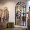 Bastia X black arched window full length mirror 200 x 100cm in a boutique fitting area beside a clothing rail