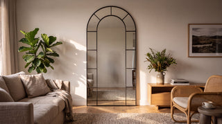 Bastia X black arched window full length mirror in a warm NZ living room, homepage hero desktop