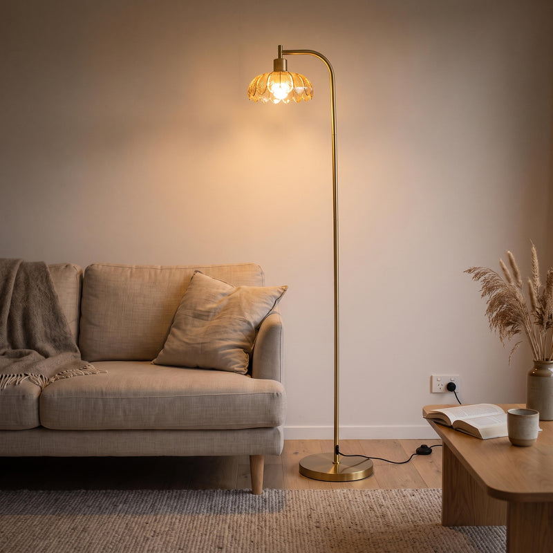 Camille Amber Petal Glass Floor Lamp glowing warm beside a sofa in a New Zealand living room