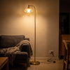 Camille Amber Petal Glass Floor Lamp glowing warm at night with the evening lights turned low