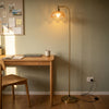 Camille Amber Petal Glass Floor Lamp lighting a quiet study nook beside a writing desk
