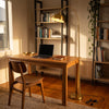 Orsay Gold Arc Floor Lamp lighting a quiet study nook above the desk