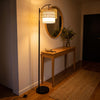 Rousseau Rattan Weave Floor Lamp adding warmth to a stylish entryway by the front door
