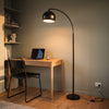 Saturne Black Globe Arc Floor Lamp lighting a home office desk from above