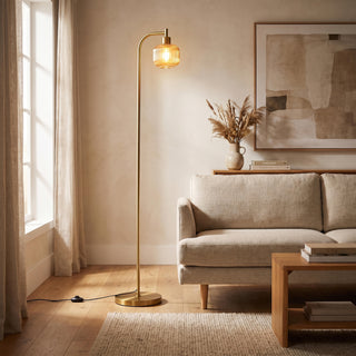 Solara Fluted Lantern Floor Lamp glowing warm beside a sofa in a New Zealand living room