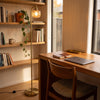 Solara Fluted Lantern Floor Lamp providing warm task lighting over a desk in a study nook