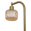 Side close up of the Solara Fluted Lantern Floor Lamp amber fluted glass shade beside the arched brass arm on white background