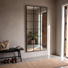 Tivoli X black rectangular window full length mirror 200 x 100cm above an entry bench on a microcement wall