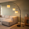 Trilogy 3-Light Floor Lamp at the end of a boucle sofa in an open plan family room