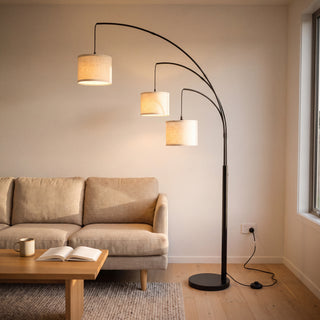 Trilogy 3-Light Floor Lamp fanning three oatmeal linen shades over a sofa in a New Zealand living room