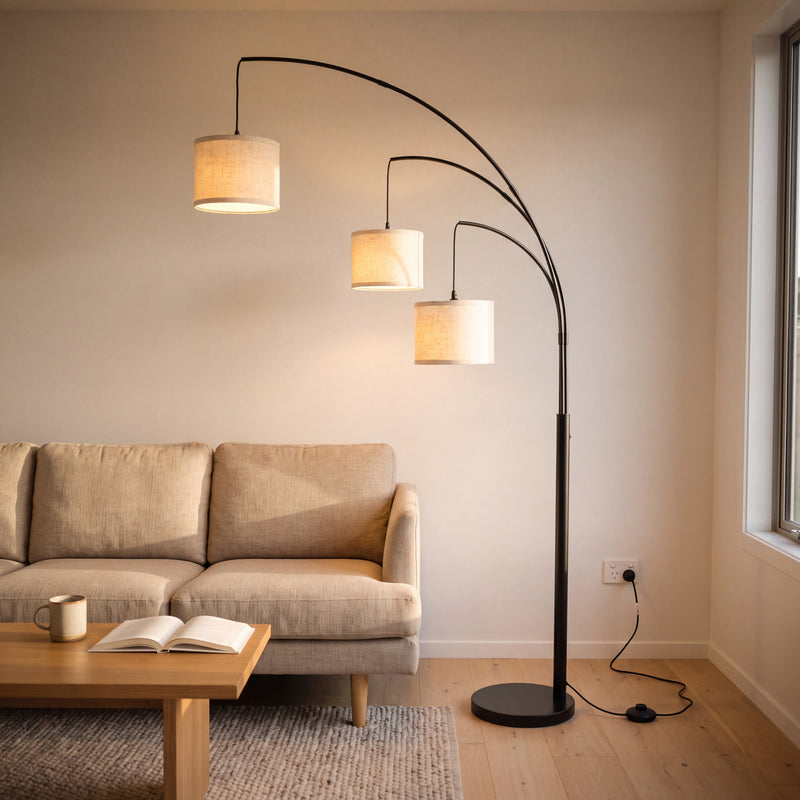Trilogy 3-Light Floor Lamp fanning three oatmeal linen shades over a sofa in a New Zealand living room