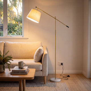 Vienna Brass Marble Base Floor Lamp beside a cream sofa in a New Zealand living room
