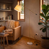 Vienna Brass Marble Base Floor Lamp angled over a leather reading chair
