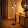 Voltaire 3-Light Cage Floor Lamp brightening a welcoming entryway beside the front door