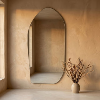 C&F Creation Cascade X Irregular Frameless Full Length Mirror 200x100cm leaning against textured plaster wall creating artistic focal point