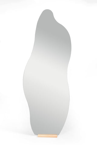 A front view of the Cascade Irregular Frameless Full-Length Freestanding Mirror with an elegant, curvy design and a wooden base.