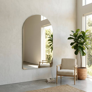 C&F Creation Cielle Arched Frameless Full Length Mirror 180x120cm leaning against concrete wall in minimal interior