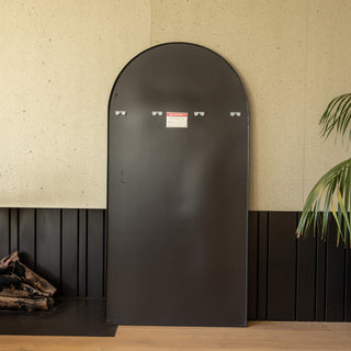 Back view of the Grandeur X arched full-length mirror showing its pre-installed metal wall hooks and smooth black backing panel. The image highlights the mirror’s sturdy construction and clean finish, demonstrating the secure wall-mount design and attention to installation details.