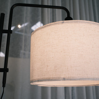 Close up of a warm woven fabric drum shade on a modern black standing lamp, highlighting texture and soft lighting. Ideal for floor lamps NZ, standing lamps, modern floor lamps and dimmable lamps. | C&F Creation NZ