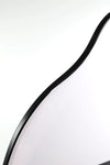 Close-up view of the curved black frame of the Nova Irregular Full-Length Mirror