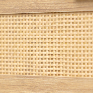 Close-up view of the Raya 6 Drawer dresser showcasing the woven rattan panel design framed in a warm oak wood finish, highlighting the natural texture and craftsmanship.