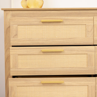 Side view of the Raya 6 Drawer dresser showing three vertically aligned drawers, each with a natural rattan panel framed in oak and finished with slim brass handles, blending elegance with a coastal-inspired look.