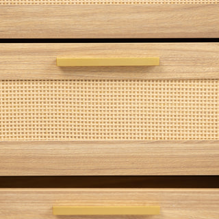 Close-up of a single drawer from the Raya 6 Drawer dresser, featuring a natural rattan weave panel framed in oak wood, finished with a slim brass handle for a modern yet organic touch.