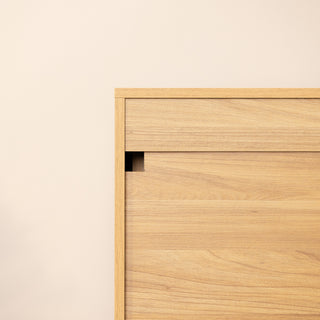 Back view of the Reede Tallboy 5-Drawer highlighting the wall safety bracket component, designed for secure attachment to the wall and added stability in the home.
