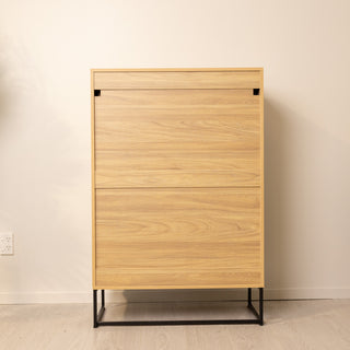 Back view of the Reede Tallboy 5-Drawer, showing the smooth oak finish panels and built-in safety bracket points for optional wall attachment, designed for added stability.